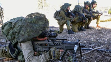 Israeli soldiers keep a position while troops train in the upper Galilee region of northern Israel near the border with Lebanon on November 8, 2023, amid increasing cross-border tensions between Hezbollah and Israel as fighting continues in the south with Hamas militants in the Gaza Strip. (AFP)