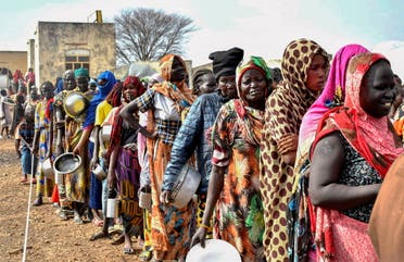 Women who fled the war-torn Sudan following the outbreak of fighting between the Sudanese army and the paramilitary Rapid Support Forces (RSF) queue to receive food rations at the United Nations High Commissioner for Refugees (UNHCR) transit center in Renk, near the border crossing point in Renk County of Upper Nile State, South Sudan May 1, 2023. (Reuters)