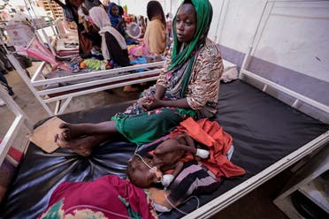 Fadila Ahmad, a Sudanese woman who fled the conflict in Geneina, in Sudan’s Darfur region, sits beside her child Abd el salam Yakoub Bakr, who is suffering from malnutrition at Médecins Sans Frontières (MSF) mission hospital in Adre, Chad July 24, 2023. (Reuters)