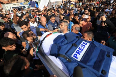 Journalists, relatives and friends pray over the body of Palestine TV journalist Mohamed Abu Hatab and eleven family members the day after they were killed when their home was hit in the Israeli bombardment of Khan Yunis, in the southern Gaza Strip on November 3, 2023. (File photo: AFP)