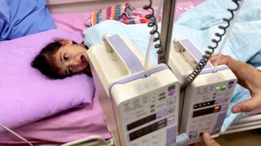 A Palestinian girl cancer patient lies on a bed in the cancer unit at Rantisi hospital, which according to doctors, is running out of supplies, putting dozens of patients at risk, amid the ongoing conflict between Israel and Hamas, in Gaza City November 7, 2023. (Reuters)