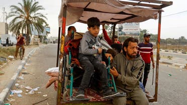 A boy in a wheelchair sits on a cart that Palestinians use to flee north Gaza to move southward, as Israeli tanks roll deeper into the enclave, amid the ongoing conflict between Israel and Hamas, in the central Gaza Strip November 12, 2023. (Reuters)