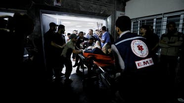 An injured person is assisted at Shifa Hospital after hundreds of Palestinians were killed in a blast at Al-Ahli hospital in Gaza that Israeli and Palestinian officials blamed on each other in Gaza City, Gaza Strip, October 17, 2023. (Reuters)