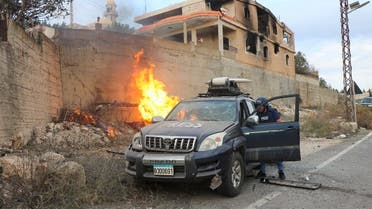 Flames erupt next to a press car following reported Israeli shelling in Lebanon's southern border village of Yaroun on November 13, 2023. (AFP)