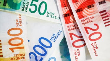 FILE PHOTO: New Israeli Shekel banknotes are seen in this picture illustration taken November 9, 2021. REUTERS/Nir Elias/Illustration/File Photo