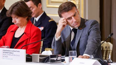 French President Emmanuel Macron looks down next to French Foreign and European Affairs Minister Catherine Colonna during an international humanitarian conference for civilians in Gaza, at the Elysee Presidential Palace, in Paris, France, on November 9, 2023. LUDOVIC MARIN/Pool via REUTERS