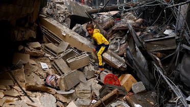 A Palestinian boy looks on at the site of an Israeli strike on a house, amid the ongoing conflict between Israel and Palestinian Islamist group Hamas, in Khan Younis in the southern Gaza Strip November 15, 2023. REUTERS/Ibraheem Abu Mustafa