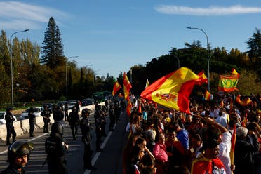 People take part in a protest as they block the road leading to Moncloa Palace, after Spain’s socialists reached a deal with the Catalan separatist Junts party for government support. (File photo: Reuters)