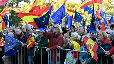 Demonstrators wave flags as they take part in a protest against an amnesty bill for people involved with Catalonia's failed 2017 independence bid, in Madrid on November 18, 2023. Spain's Socialist leader Pedro Sanchez was sworn yesterday as prime minister for another term with the right vowing to keep up its protests against his decision to grant Catalan separatists an amnesty. (Photo by JAVIER SORIANO / AFP)