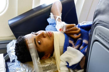 An injured child waits inside the plane as Palestinian children and families who were evacuated from Gaza amid the ongoing conflict between Israel and Palestinian Islamist group Hamas, arrive to receive treatment in Abu Dhabi, United Arab Emirates, November 18, 2023.