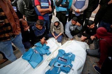 Palestinians mourn local journalists Hassouna Sleem and Sary Mansour, who were killed in an Israeli strike on a house, at a hospital in the central Gaza Strip, November 19, 2023. (Reuters)