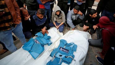 Palestinians mourn local journalists Hassouna Sleem and Sary Mansour, who were killed in an Israeli strike on a house, at a hospital in the central Gaza Strip, November 19, 2023. (Reuters)