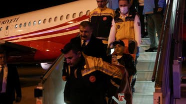 Turkish Health Minister Fahrettin Koca walks as medical staff carry a Palestinian cancer patient who was evacuated from Gaza to Egypt and brought to Turkey by plane, at Esenboga Airport in Ankara, Turkey November 16, 2023. REUTERS/Cagla Gurdogan