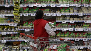 A worker arranges goods in a Reliance su