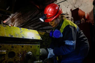 Nataliia, 43-years-old, connects power to a mine train battery charger, in her workplace at an underground mine, amid Russia's attack on Ukraine, in Dnipropetrovsk region, Ukraine November 17, 2023. (Reuters)