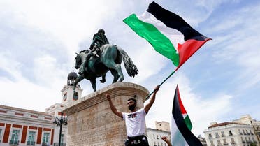 A man holds a flag during a protest in support of Palestinians amid their ongoing conflict with Israel, at Puerta del Sol square, in Madrid, Spain May 15, 2021. (Reuters)
