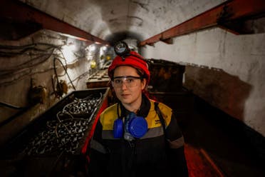 Krystyna, 22-years-old, stands next to a mine train battery at her workplace at an underground mine, amid Russia's attack on Ukraine, in Dnipropetrovsk region, Ukraine November 17, 2023. (Reuters)