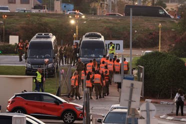 Israeli security forces stand next to buses waiting at the helipad of Tel Aviv's Schneider medical centre on November 24, 2023, amid preparations for the release of Israeli hostages held by Hamas in Gaza in exchange for Palestinian prisoners later in the day. (AFP)