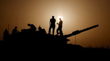 Israeli soldiers stand on a tank, amid the ongoing conflict between Israel and the Palestinian group Hamas, near Israel's border with Gaza in southern Israel, November 23, 2023. (Reuters)