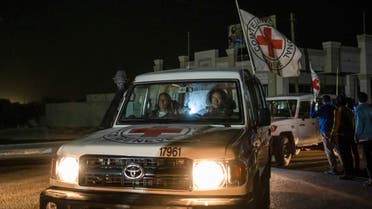 A Red Cross convoy carrying Israeli and foreign hostages heads to Egypt from the Gaza Strip at the Rafah border crossing on Sunday, Nov. 26, 2023. (AP Photo/Fatima Shbair)