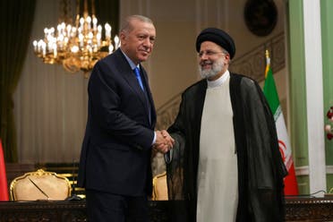 Turkish President Recep Tayyip Erdogan, left, and his Iranian counterpart Ebrahim Raisi shake hands at the conclusion of their joint press briefing at the Saadabad Palace, in Tehran, Iran, Tuesday, July 19, 2022. (AP)