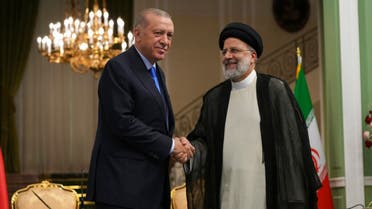 Turkish President Recep Tayyip Erdogan, left, and his Iranian counterpart Ebrahim Raisi shake hands at the conclusion of their joint press briefing at the Saadabad Palace, in Tehran, Iran, Tuesday, July 19, 2022. (AP Photo/Vahid Salemi)