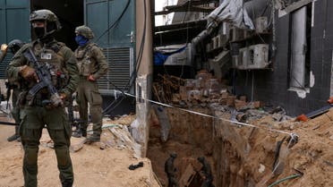 Israeli soldiers stand near the opening to a tunnel at Al Shifa Hospital compound in Gaza City, amid the ongoing ground operation of the Israeli army against Palestinian group Hamas, in the Gaza Strip, November 22, 2023. (Reuters)