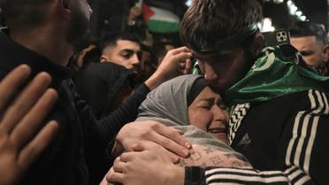 Omar Atshan, 17, is hugged by his mother after being released from an Israeli prison in the West Bank town of Ramallah, Sunday Nov. 26, 2023. (AP)
