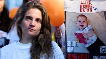 A protestor stands next to a sign calling for the release of Kfir Bibas, 10 months, during a protest calling for the immediate release of hostages, especially Shiri Bibas, 32, her husband Yarden Bibas, 34 and their children Kfir Bibas, 10 months, and Ariel, 4, during the hostages-prisoners swap deal between Hamas and Israel, in Tel Aviv, Israel, November 28, 2023. (Reuters)