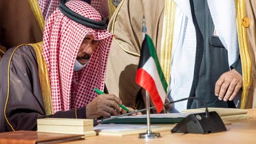 A handout picture provided by the Saudi Royal Palace on January 5, 2021, shows Kuwaiti Emir Sheikh Nawaf al-Ahmad Al-Sabah signing a document during the opening session of the 41st Gulf Cooperation Council (GCC) summit in the northwestern Saudi city of al-Ula. (AFP)