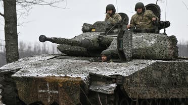 Ukrainian servicemen check their Sweden made CV90 armored infantry combat vehicle on a position pointing in the direction of Bakhmut in the Donetsk region on November 27, 2023, amid the Russian invasion of Ukraine. (AFP)