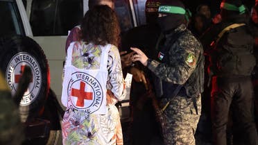 Hamas and Islamic Jihad fighters speak with members of the Red Cross during the release of hostages in Rafah, in the southern Gaza Strip on November 28, 2023. (AFP)