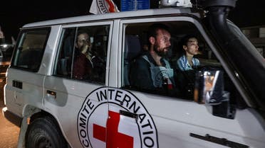 An International Red Cross vehicle carrying Israeli Russian hostage Ron Krivoy released by Hamas drives towards the Rafah border point with Egypt ahead of a transfer to Israel on November 26, 2023. (AFP)