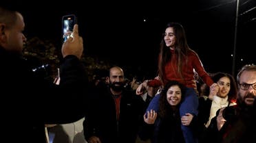 Newly released Palestinian prisoner Rouba Assi is carried by supporters during a welcome ceremony following the release of prisoners from Israeli jails in exchange for Israeli hostages held in Gaza by Hamas since the October 7 attacks, in Ramallah in the occupied West Bank on November 28, 2023. (AFP)