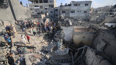 Palestinians check the damage of houses destroyed in an Israeli strike on Khan Yunis in the southern Gaza Strip on December 1, 2023, after the expiration of a seven-day truce between Israel and Hamas militants. (AFP)