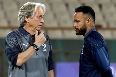 Al Hilal's Brazilian forward Neymar speaks with his Portuguese coach Jorge Jesus during a training session. (AFP)