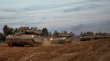 Israeli soldiers move tanks at a staging area near the border with the Gaza Strip, southern Israel, Tuesday, Nov. 28, 2023. on the fifth day of a temporary cease-fire between Israel and Hamas. (AP PhotoOhad Zwigenberg