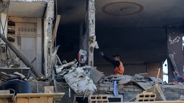 People check the damage in a house hit by Israeli bombing in Khan Yunis in the southern Gaza Strip on December 3, 2023. (AFP)