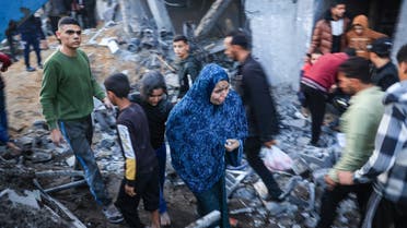  Palestinians check the damages after an Israeli strike in Rafah in the southern Gaza Strip on December 3, 2023. (AFP)
