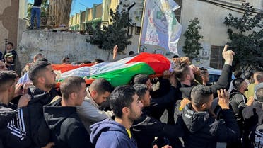 Mourners carry the body of 38-year-old Palestinian, Ahmad Assi, who was killed in an Israeli settler raid, during his funeral near Salfit in the Israeli-occupied West Bank December 3, 2023. REUTERS/Ali Sawafta