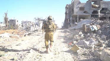 An Israeli soldier takes position during the ongoing ground operation of the Israeli army against Palestinian Islamist group Hamas, in a location given as Jabalya, in Gaza, in this handout still image obtained from a video released on December 2, 2023. (Reuters)