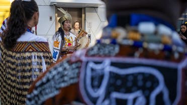 Indigenous environmental activists play traditional instruments at the entrance of the COP28 United Nations climate summit venue in Dubai on December 1, 2023. (AFP)