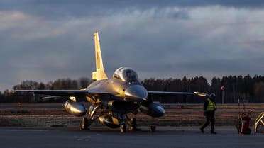 A pilot sits inside the jet aircraft as Norway marks the first delivery of used F-16 fighters to Romania at Rygge air station, Norway November 28, 2023. (Reuters)