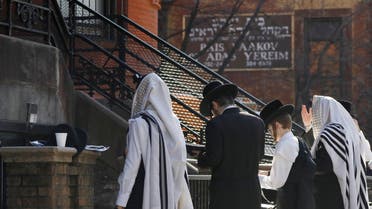 Hasidic Jewish men gather for a morning prayer outside of a synagogue in New York City in this file photo. (Reuters) 