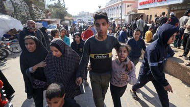 A family arrives at Khan Younis’s Al-Nasser Hospital after their home was hit in an Israeli strike in the southern Gaza Strip city on December 7, 2023. (AFP)