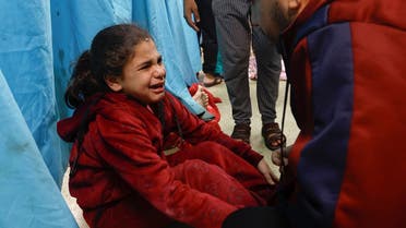 A wounded Palestinian child sits on the floor of Al-Nasser Hospital following Israeli strikes, amid the ongoing conflict between Israel and Hamas, in Khan Younis in the southern Gaza Strip, on December 8, 2023. (Reuters)