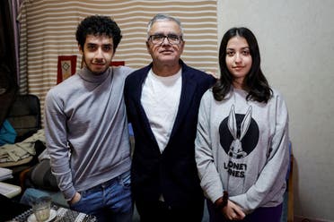 Iranian journalist Taghi Rahmani (C), husband of Iranian rights campaigner and 2023 Nobel Peace Prize laureate Narges Mohammadi, poses with his 17 year old children, Ali (L) and Kiana (R) during an interview in his appartement in Paris on December 5, 2023. (AFP)