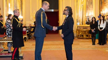Pakistani entrepreneur Faraz Khan, right, shares a handshake with Britain's Prince William as he receives his Order of the British Empire (MBE) award in London, United Kingdom on December 7, 2023. (Photo courtesy: @fksquared/X)