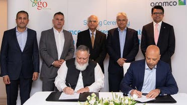 In this handout photo, taken and released by Saudi Aramco on December 12, 2023, Aramco Executive Vice President of Products and Customers, Yasser Mufti (right), signing the agreement with GO founder and CEO Khalid Riaz (left) in Riyadh. (Photo courtesy: Saudi Aramco)