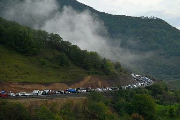 Vehicles carrying refugees from Nagorno-Karabakh, a region inhabited by ethnic Armenians, queue on the road leading towards the Armenian border, in Nagorno-Karabakh, September 25, 2023. (Reuters)